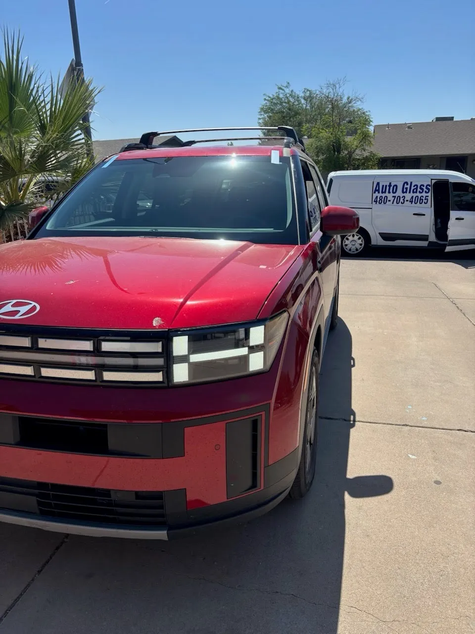 Windshield replacement on red Hyundai SUV